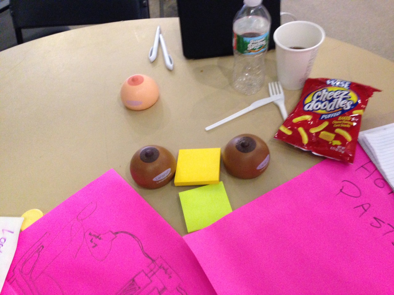 Detritus at hackathon's end includes junk food, coffee, diagrams and squeezable stress balls in the shape of breasts. (Carey Goldberg/WBUR)