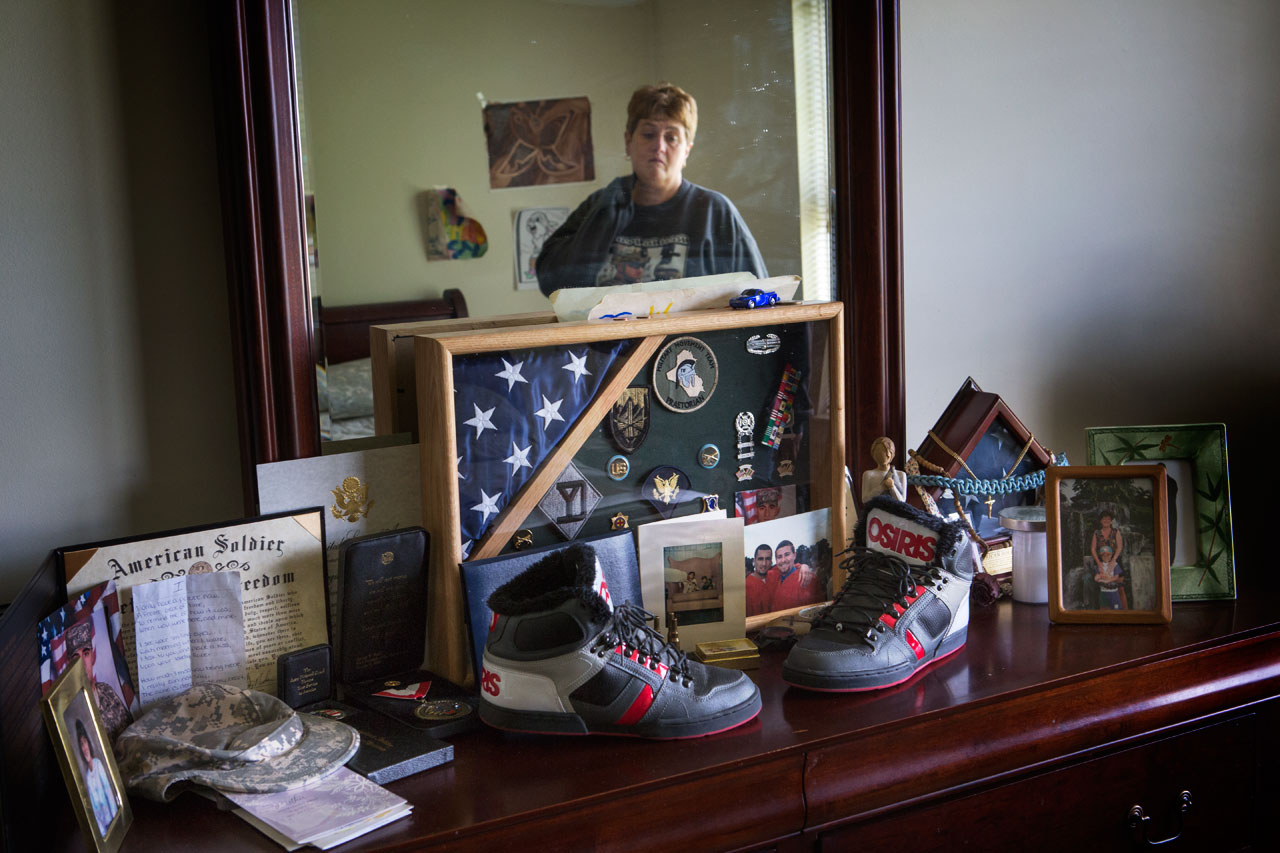 Tammy says she spends a few moments in front of her dresser everyday, which is covered with pictures of her son and his military medals. (Jesse Costa/WBUR)