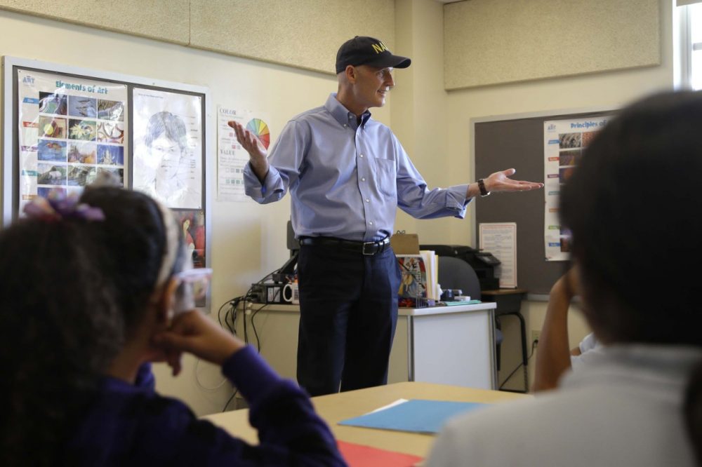 Republican Florida Gov. Rick Scott talks with students before holding a news conference with Alberto Carvalho, superintendent of Miami-Dade County Public Schools, at Southside Elementary School, Wednesday, Aug. 27, 2014, in Miami. (AP)