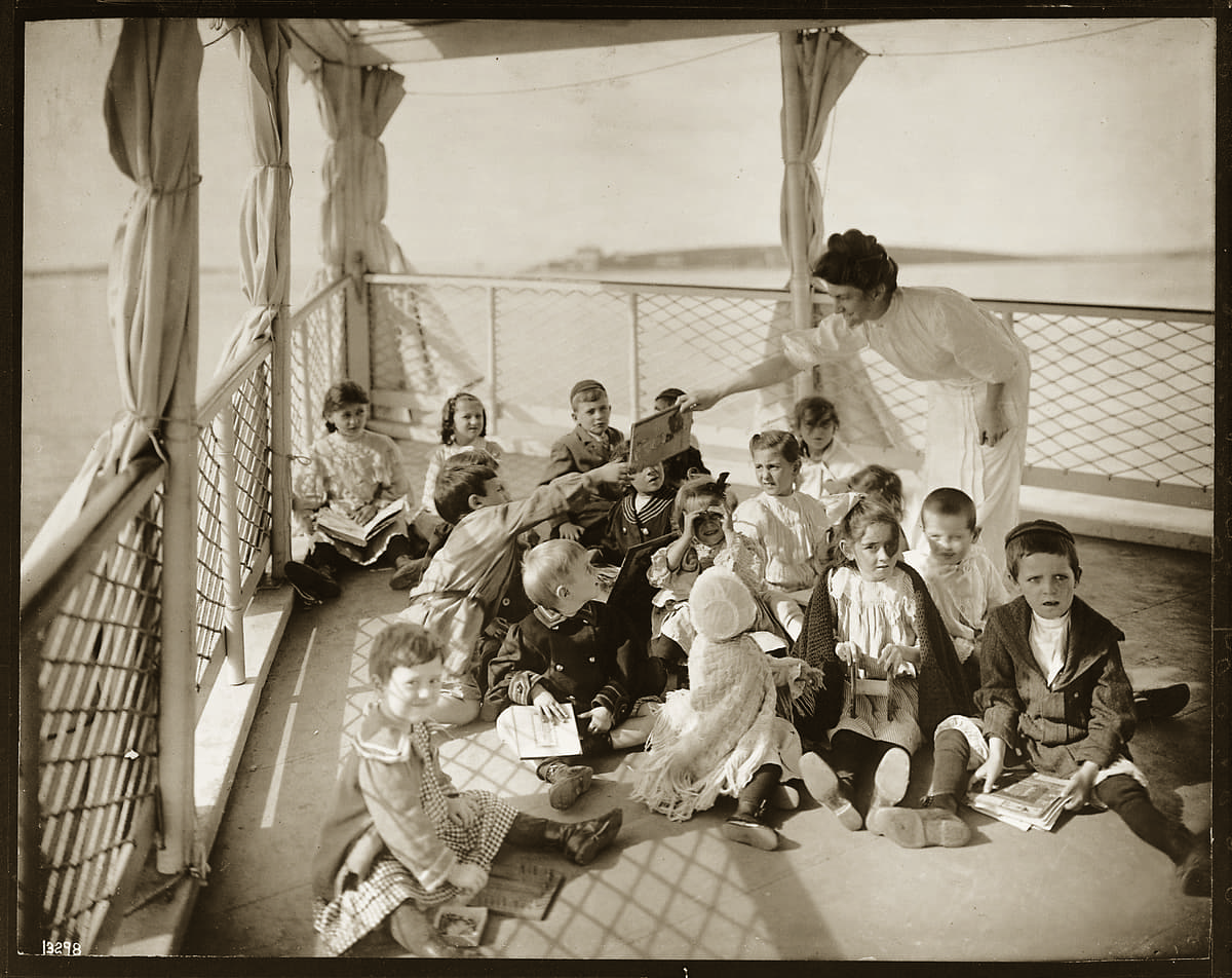 Mrs. Parker Field, the superintendent&#039;s wife, teaches children&#039;s games and songs by way of the entertaining the kindergarten class on the open-air deck. Taken in 1906. (Courtesy Tufts Medical Center)