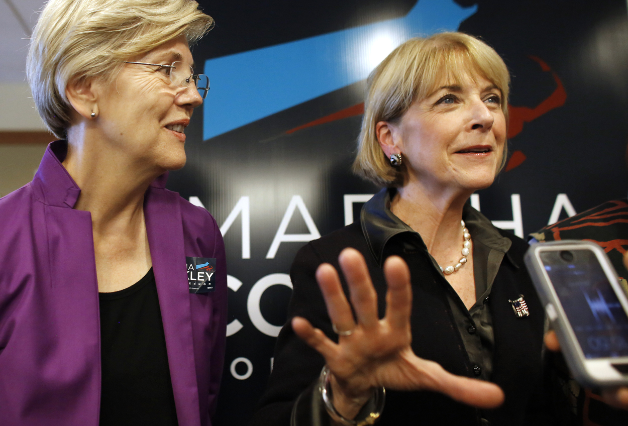 Martha Coakley, right, speaks with reporters alongside U.S. Senator Elizabeth Warren following a roundtable discussion at offices of the Service Employees International Union last month. (Steven Senne/AP)