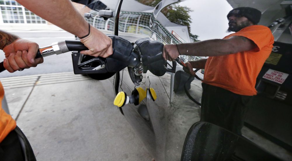 Dana Ripley, of Winthrop, Mass., fills the gas tank of his truck at a service station in Andover, Mass. (Charles Krupa/AP)