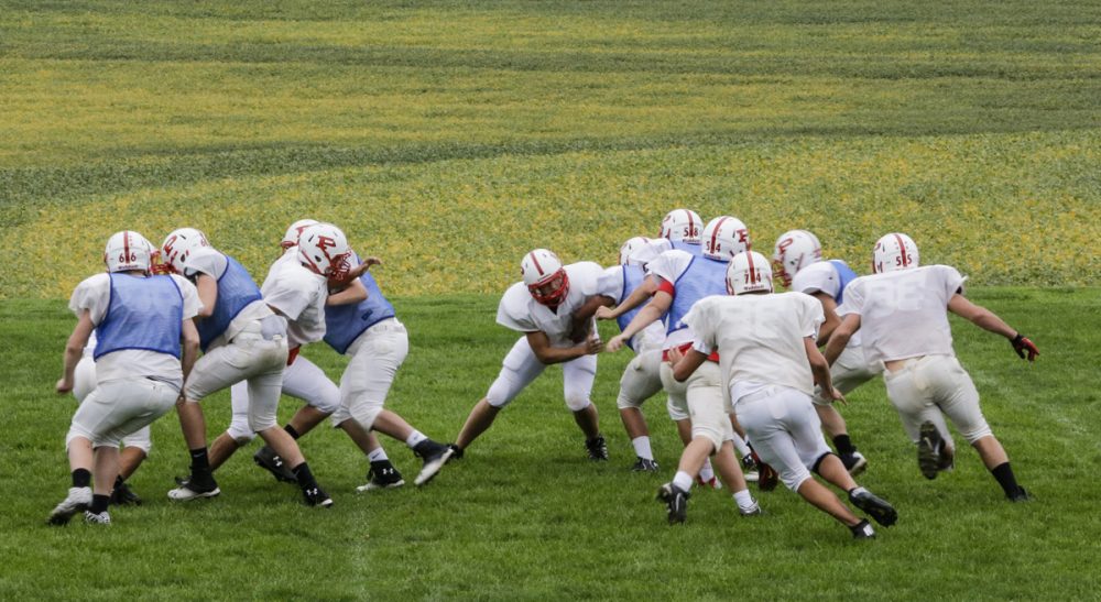 Steve Almond: "What is a dangerous, insanely commercialized form of athletic combat doing in our public schools?" Pictured: Members of the Platteview High School football team practice in Springfield, Neb. (Nati Harnik/AP)