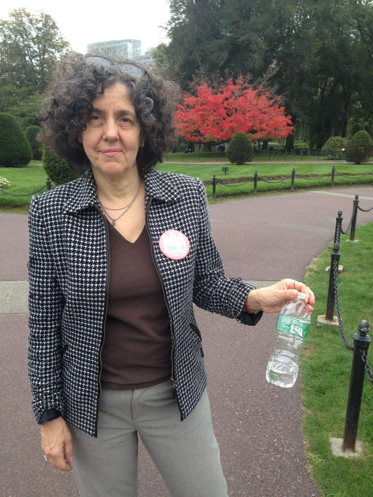 Janet Domenitz of MASSPIRG shows water bottle litter she found in the Public Garden. (Curt Nickisch/WBUR)