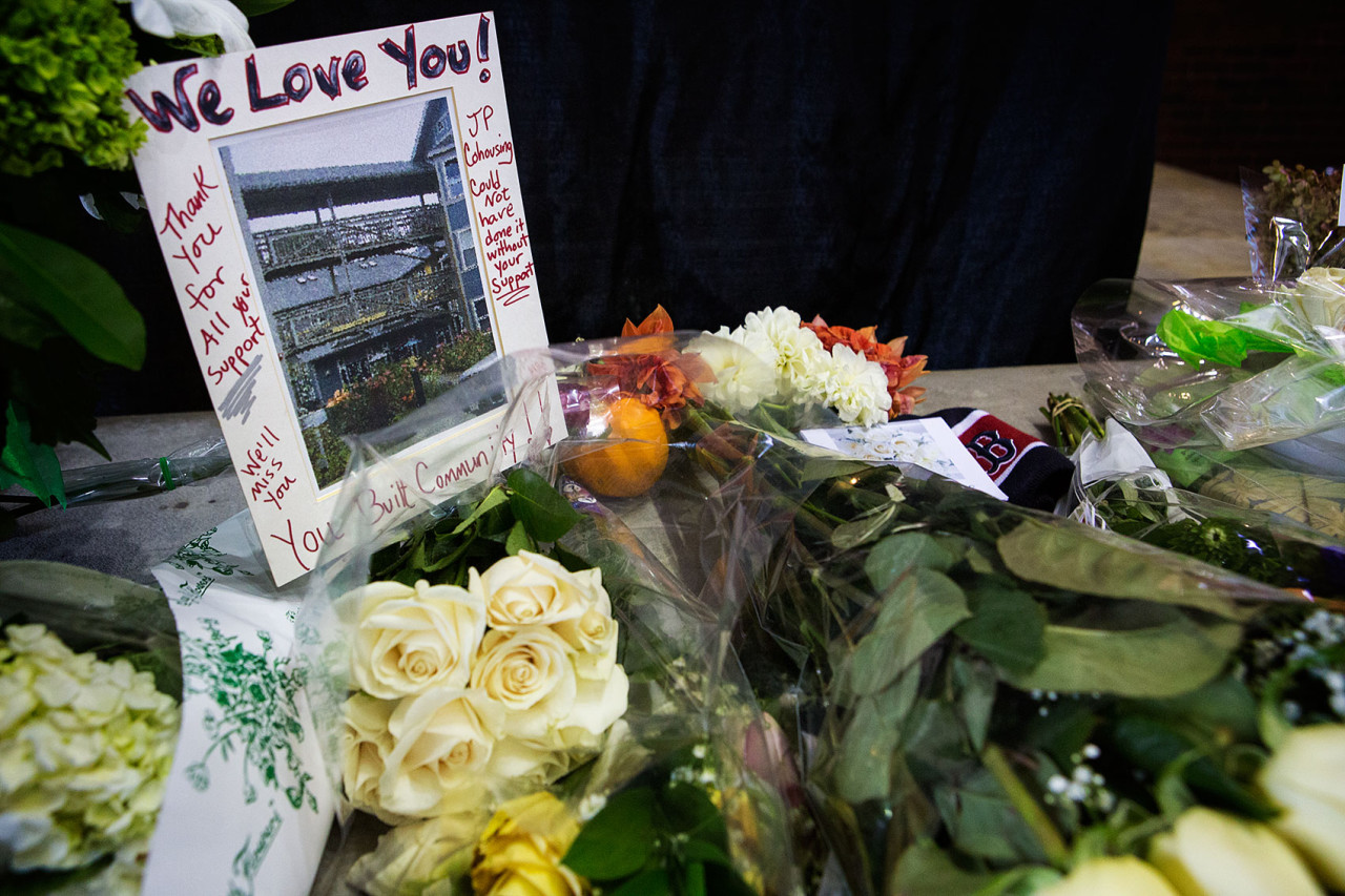 A sign reads “We Love You” at the memorial in the lobby of City Hall. (Jesse Costa/WBUR)