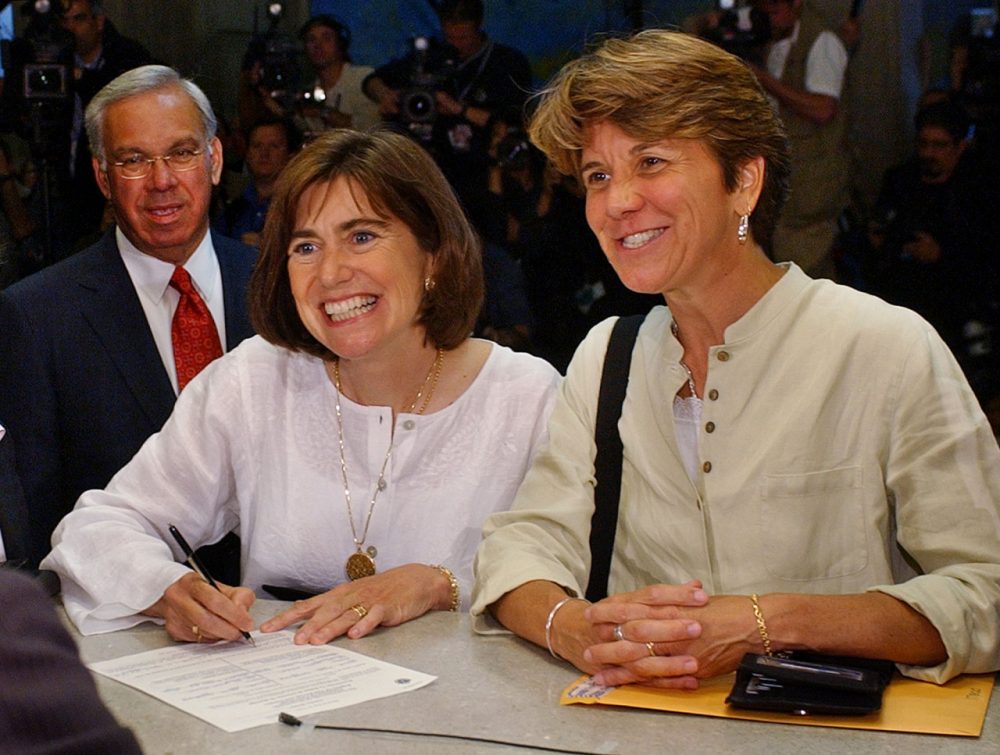 Hillary and her partner, Julie Goodridge, left, the lead plaintiffs in the Massachusetts gay marriage lawsuit, fill out their marriage license application, with Boston Mayor Tom Menino looking over their shoulder, at Boston City Hall in Boston, Monday May 17, 2004. They are getting married later Monday. (Charles Krupa/AP)