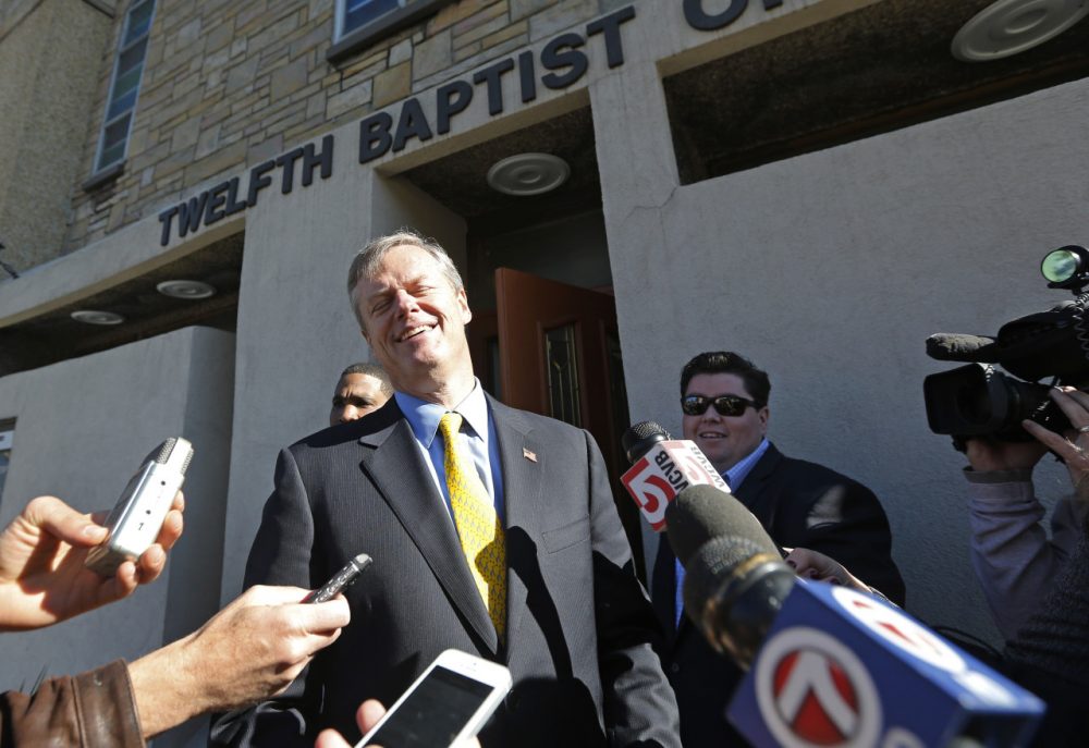 Republican gubernatorial candidate Charlie Baker talks with reporters after speaking to members of The Black Ministerial Alliance of Greater Boston in Roxbury Monday. (Elise Amendola/AP)