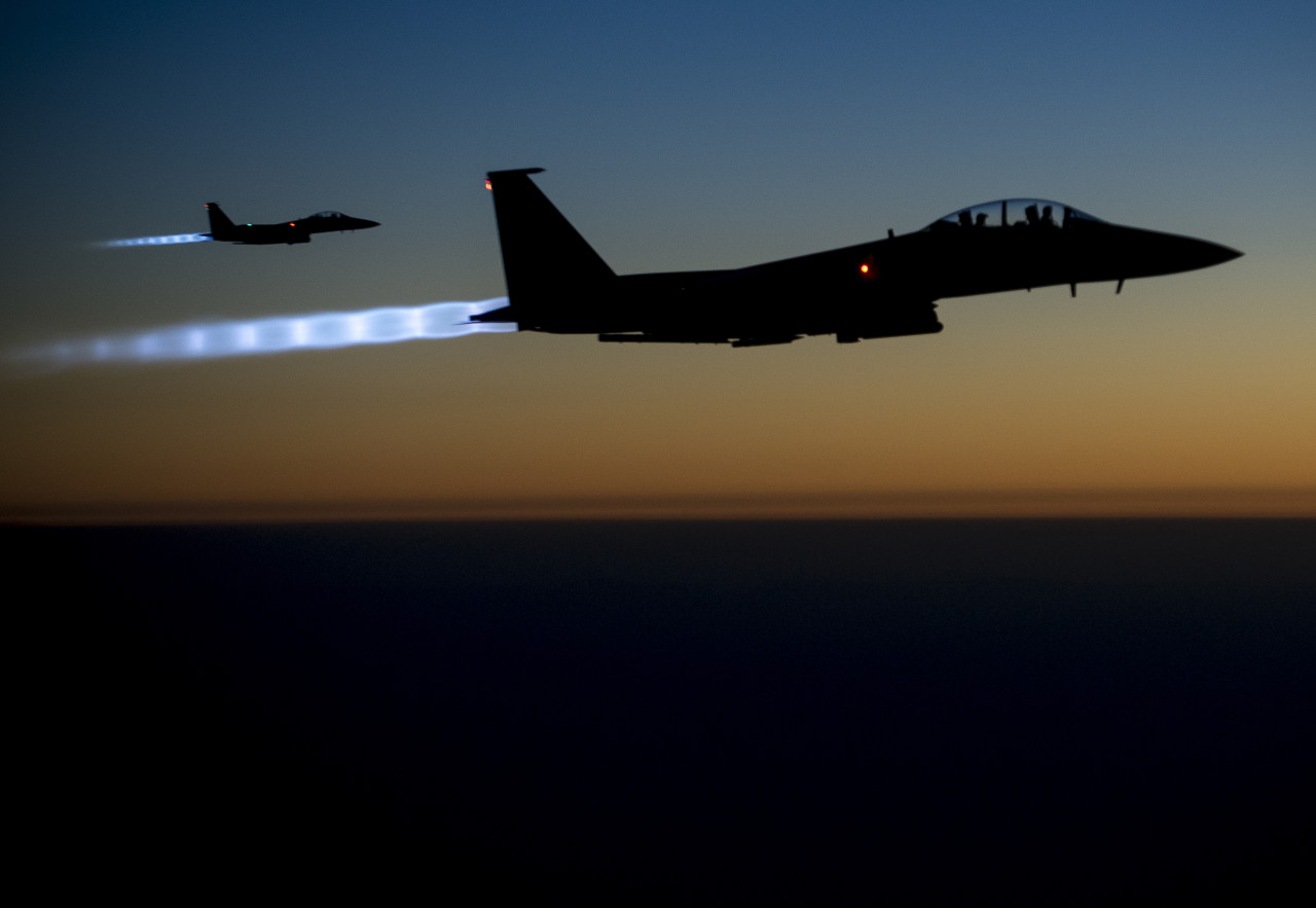 In this Tuesday, Sept. 23, 2014, photo, released by the U.S. Air Force, a pair of U.S. F-15E Strike Eagle flies over northern Iraq, after conducting airstrikes in Syria. U.S.-led coalition warplanes bombed oil installations and other facilities in territory controlled by Islamic State militants in eastern Syria on Friday, Sept. 26, 2014, taking aim for a second consecutive day at a key source of financing that has swelled the extremist group's coffers, activists said. (AP Photo/U.S. Air Force, Matthew Bruch)