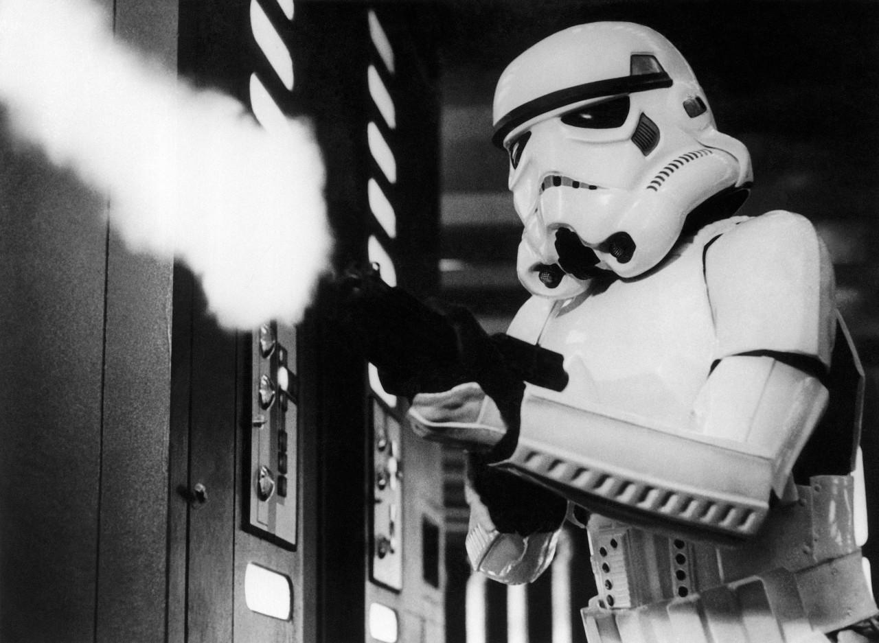 In this image provided by 20th Century-Fox Film Corporation, a scene from "Star Wars" movie released by 20th Century-Foxin 1977, where an Imperial stormtrooper, one of the fearsome soldiers of the Galactic Empire, fires at the fleeing Princess Leia. (AP Photo/20th Century-Fox Film Corporation)