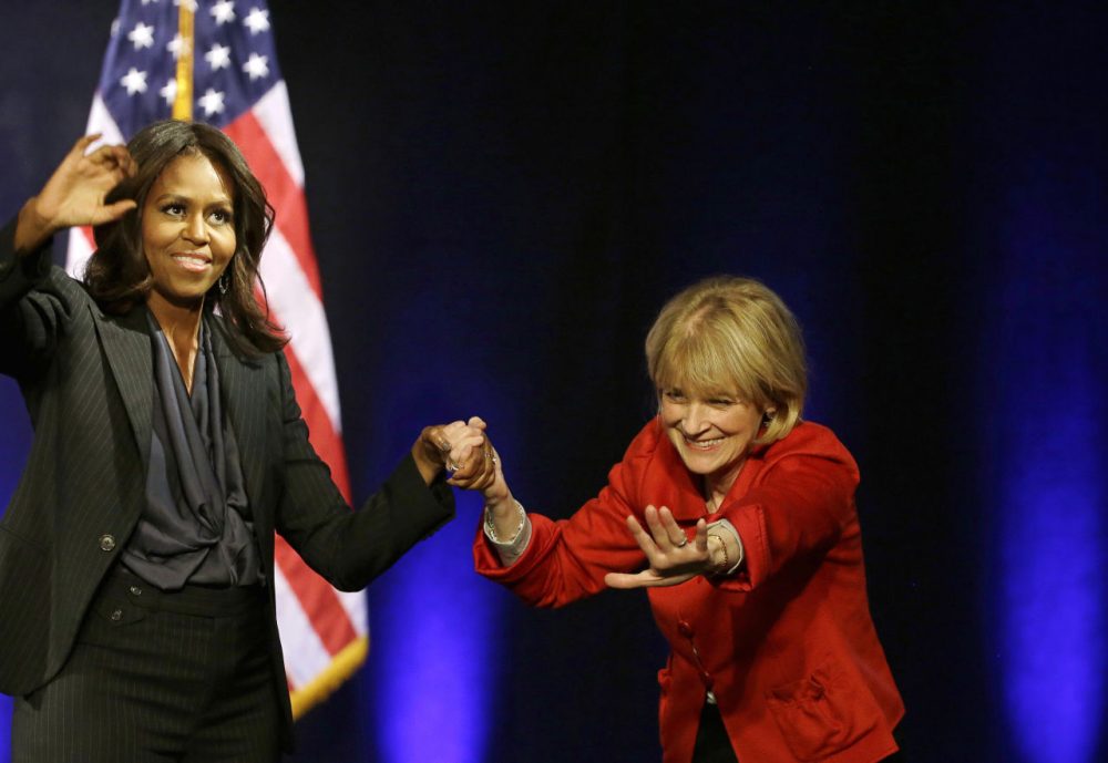 First lady Michelle Obama and Massachusetts Democratic gubernatorial candidate Martha Coakley wave to supporters after a campaign event, Friday at the Strand Theatre. (Stephan Savoia/AP)