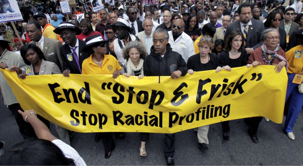 Carol Rose: &quot;Police in Boston have targeted thousands of black and brown people, even when those people have done nothing wrong.&quot; Pictured: A 2012 march against racial profiling, led by the Rev. Al Sharpton along Fifth Avenue in New York City. In 2013, the NYPD faced legal challenges over its stop, question and frisk policy. A similar legal battle could be coming to Boston given findings that the Boston Police Department has been found to use racial profiling as a basis for stops and searches. (Seth Wenig/AP)
