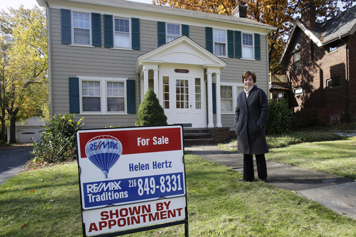 Realtor Helen Hertz stands in front of one of her listings in Cleveland Heights, Ohio Friday, Oct. 24, 2014. Hertz, a real estate agent for more than three decades, has seen firsthand what has happened to the market in the wake of the recession and foreclosure crisis. (AP)