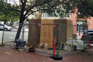 The statue of Poe went into the ground more than a week ago and is hidden by a wooden box. (Courtesy Randy Catlin, Shawmut Design and Construction)