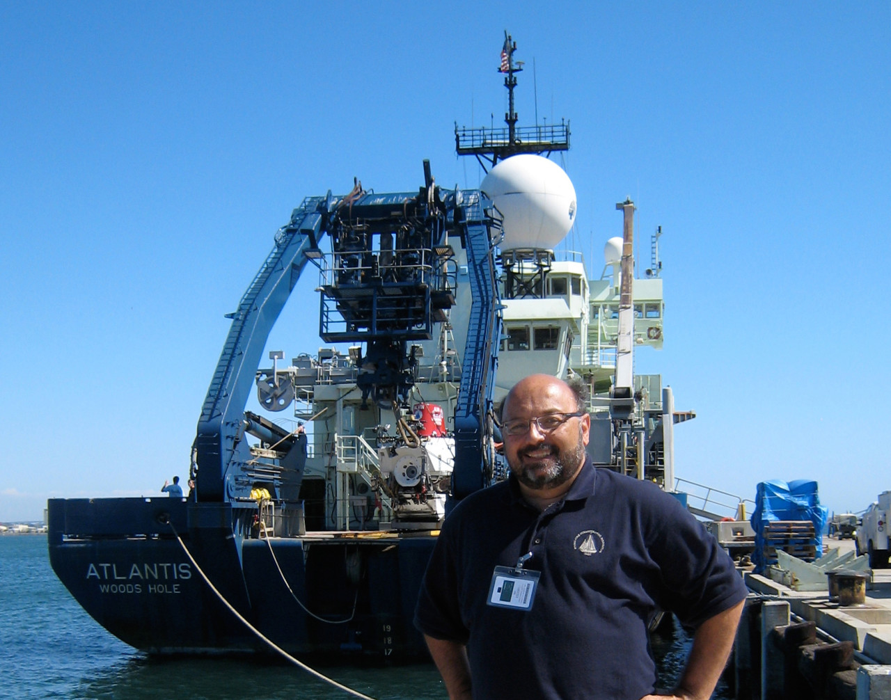 David Gallo is pictured with R/V Atlantis behind him. (Woods Hole Oceanographic Institution)