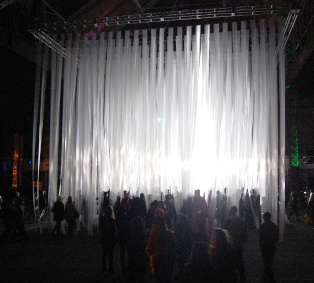 People stood inside the cube of streamers in the old power plant. (Greg Cook)
