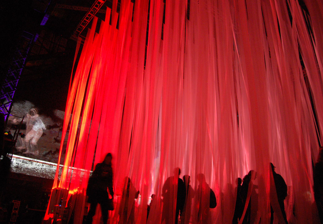 Spotlights illuminated fabric streamers hanging inside the old power plant. (Greg Cook)