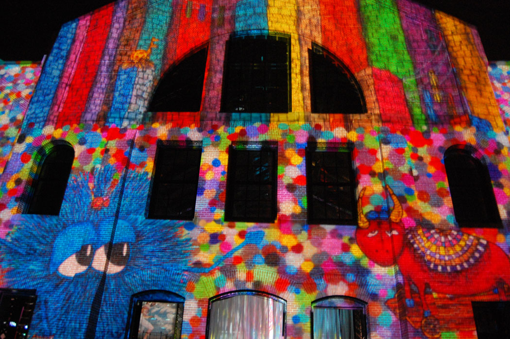 Art by Caleb Neelon is projected across the exterior of the old power plant. (Greg Cook)