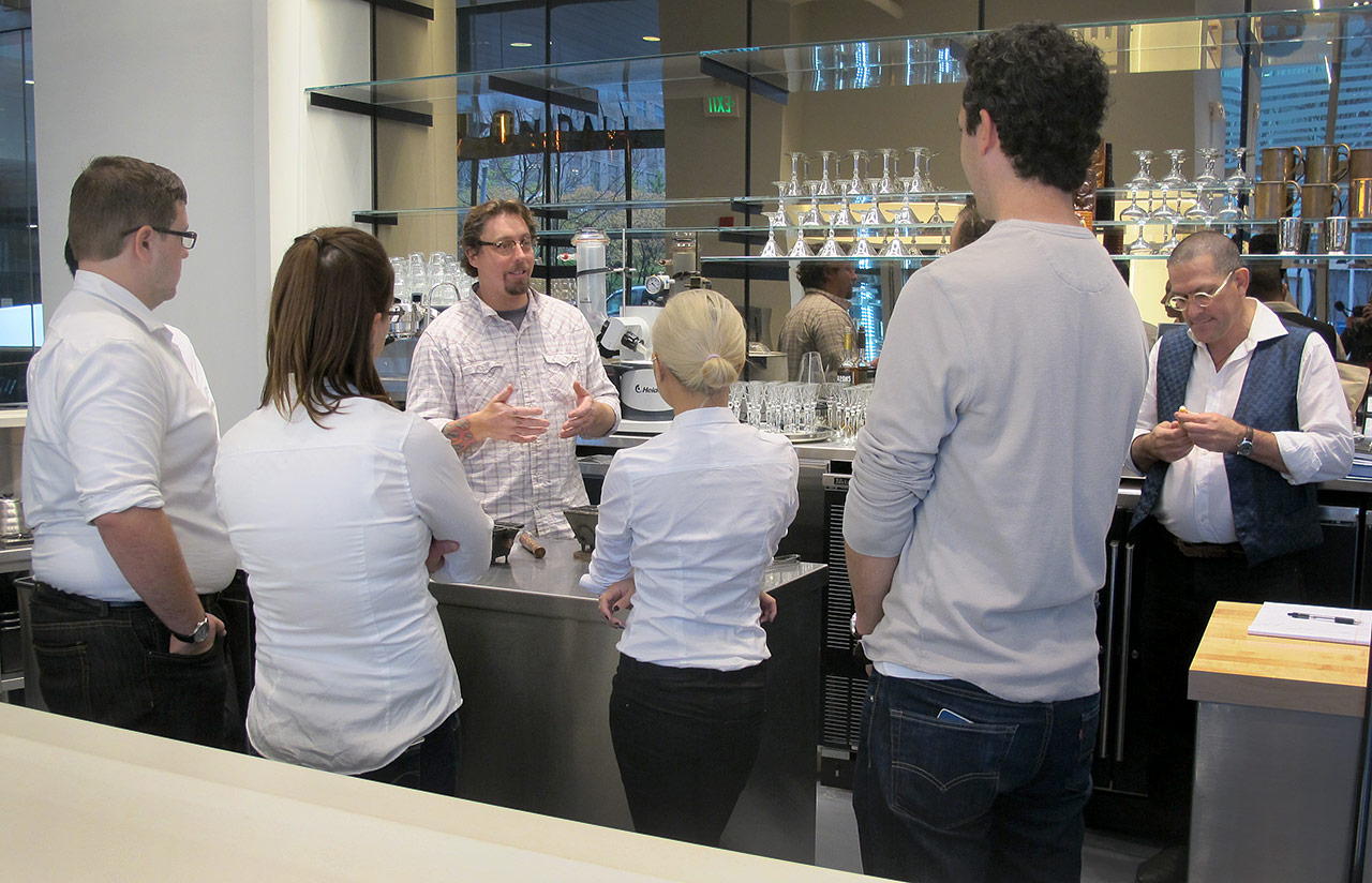 Bartender Todd Maul talks to the staff at the bar in the Cafe ArtScience, Cambridge. (Andrea Shea/WBUR)