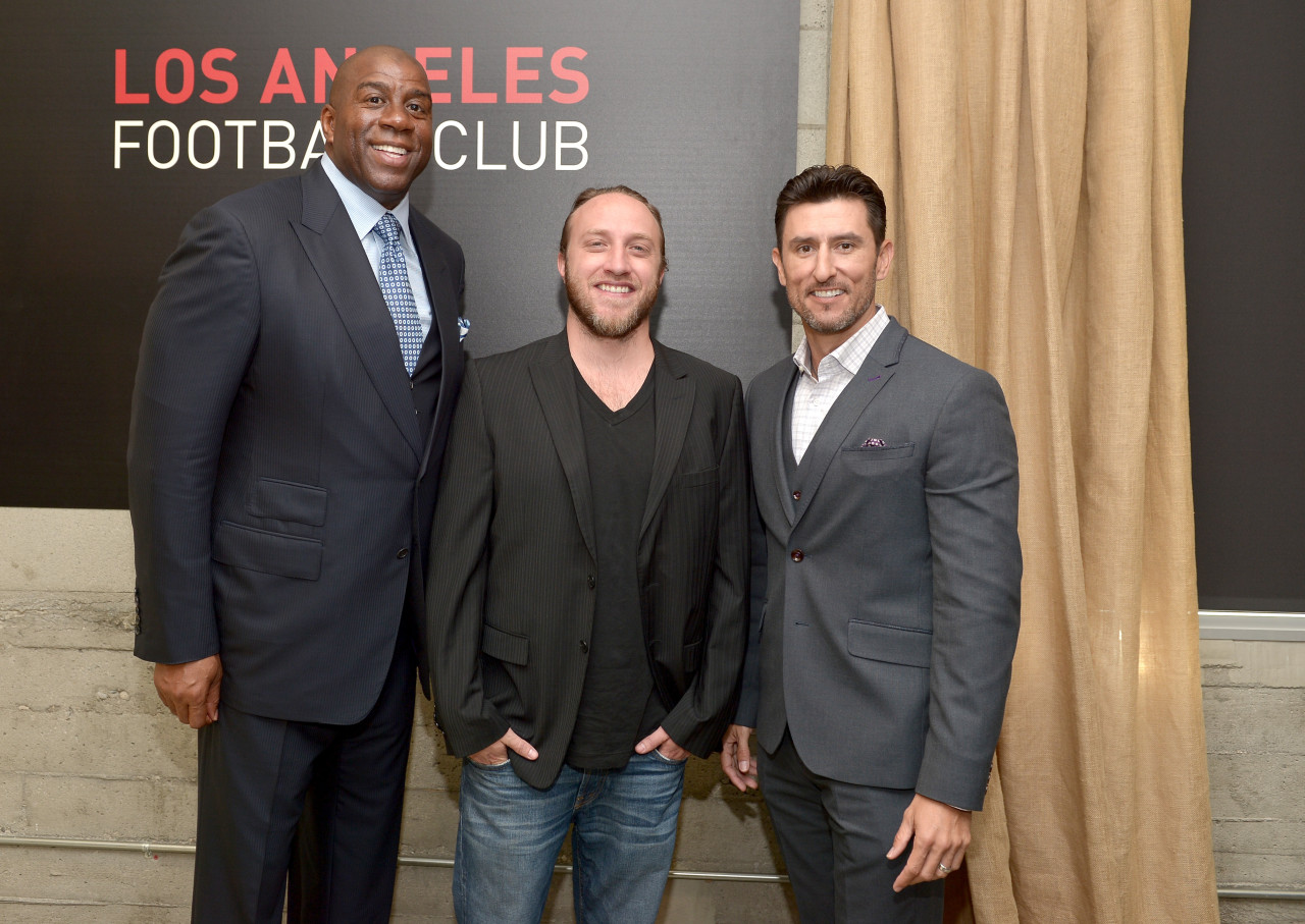 Former Laker Magic Johnson (left), Chad Hurley (middle) and former MLB shortstop Nomar Garciaparra are also owners of the new club. (Charley Gallay/Getty Images)