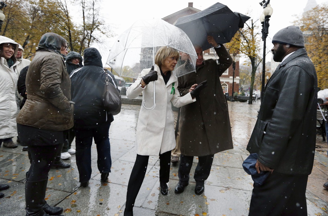 Massachusetts Democratic gubernatorial candidate Martha Coakley, center left, gestures to mourners in line to pay their respects to former Boston Mayor Thomas Menino outside Faneuil Hall. (Michael Dwyer/AP)
