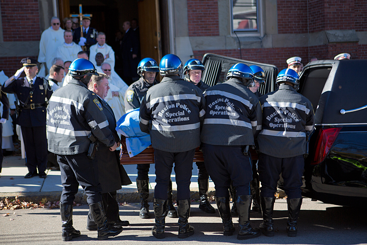 Pallbearers remove the casket of Thomas Menino from the hearse at the Most Precious Blood Parish in Hyde Park. (Jesse Costa/WBUR)