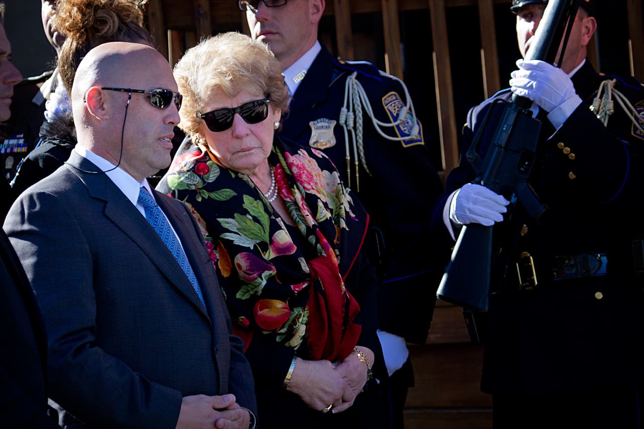 The mayor's wife of 48 years, Angela Menino, and their son, Tom Menino, Jr., prepare to follow the casket into the church. (Jesse Costa/WBUR)