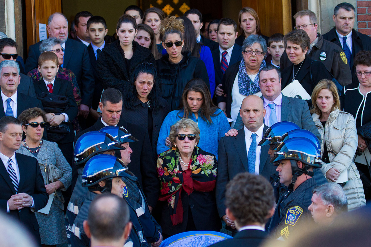 Surrounded by family, Angela Menino, Mayor Thomas Menino's wife of 48 years, stands in front of her husband's casket outside of the Most Precious Blood Parish following a funeral ceremony in her husband's honor. (Jesse Costa/WBUR)
