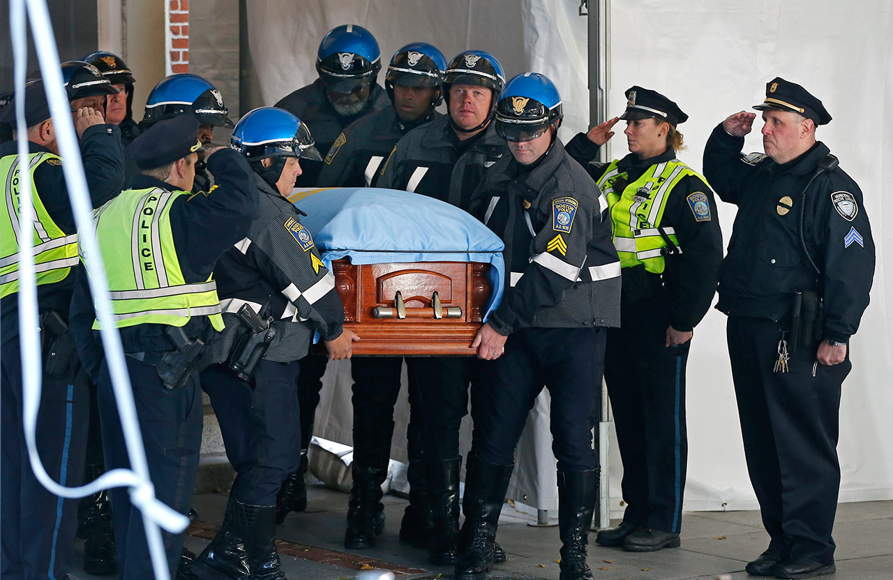 Boston police poll bearers carry the casket of former Boston Mayor Tom Menino out of Faneuil Hall. (Elise Amendola/AP)