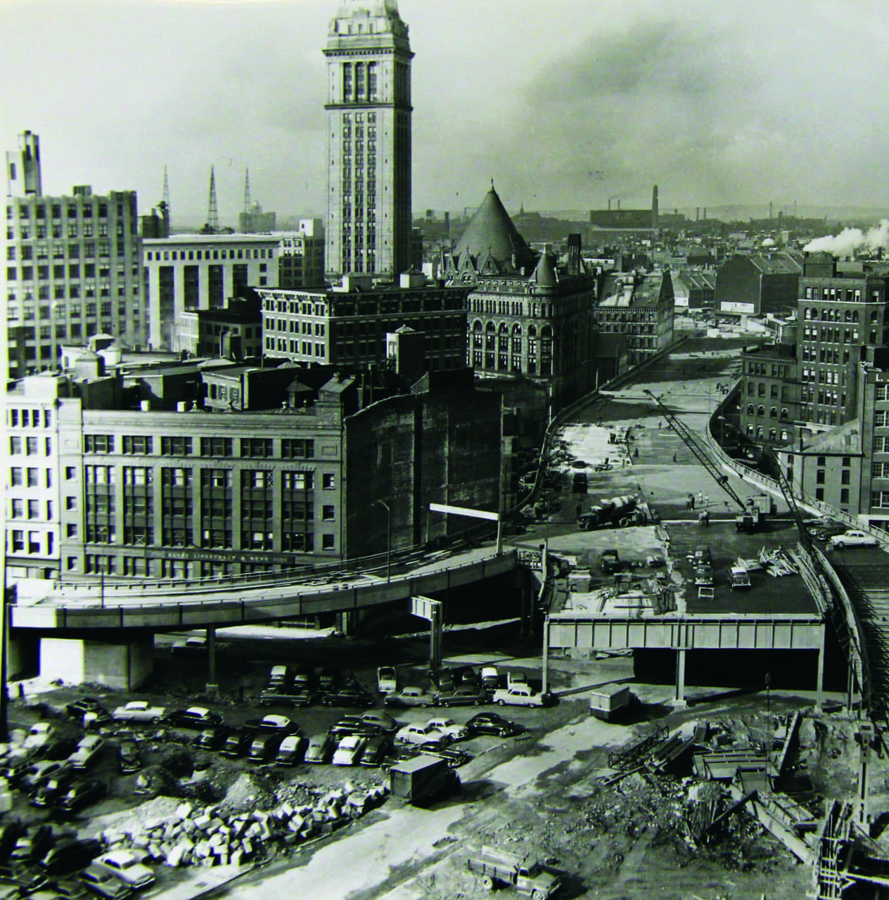 Loathed from inception, the Central Artery cut a swath through the city. Called the "Distress Way" and the "World's Largest Parking Lot," this huge gash, now underground, will never be missed. Downtown, 1954. (Courtesy Mass. State Archives)