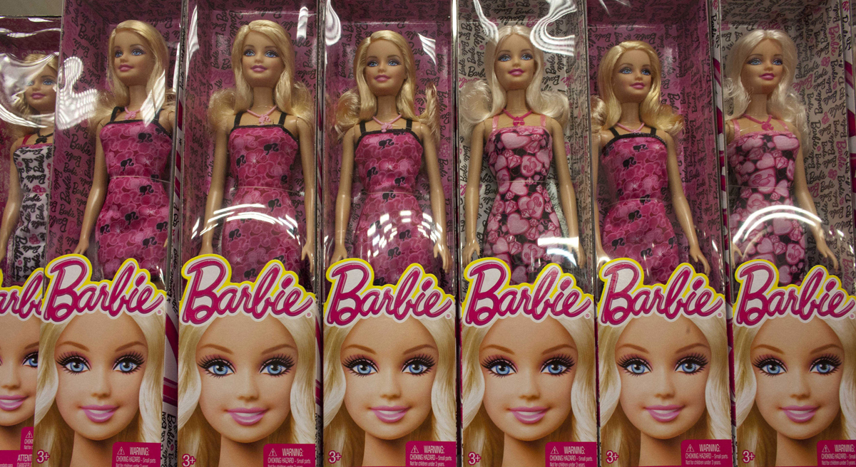 Mattel gets it wrong -- again -- with a "computer engineer" Barbie who can't code and needs help from boys. To say nothing of that hot pink laptop. (Ariana Cubillos/AP)