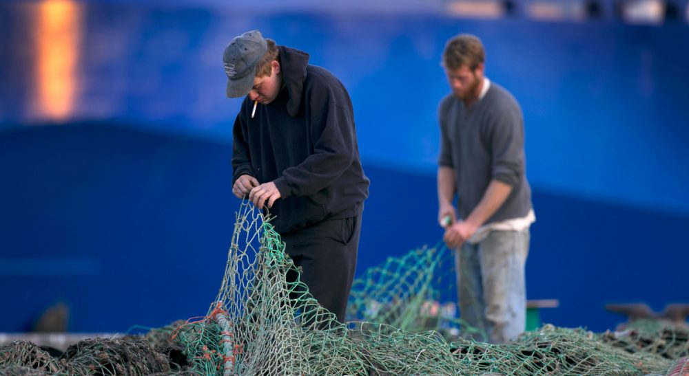 David Ropeik on overfishing and its devastating effects off- and on-shore. Pictured: Fishermen Ed Stewart, left, and Tannis Goodsen mend groundfishing nets on Merrill Wharf in Portland, Maine in 2013. (Robert F. Bukaty/AP)