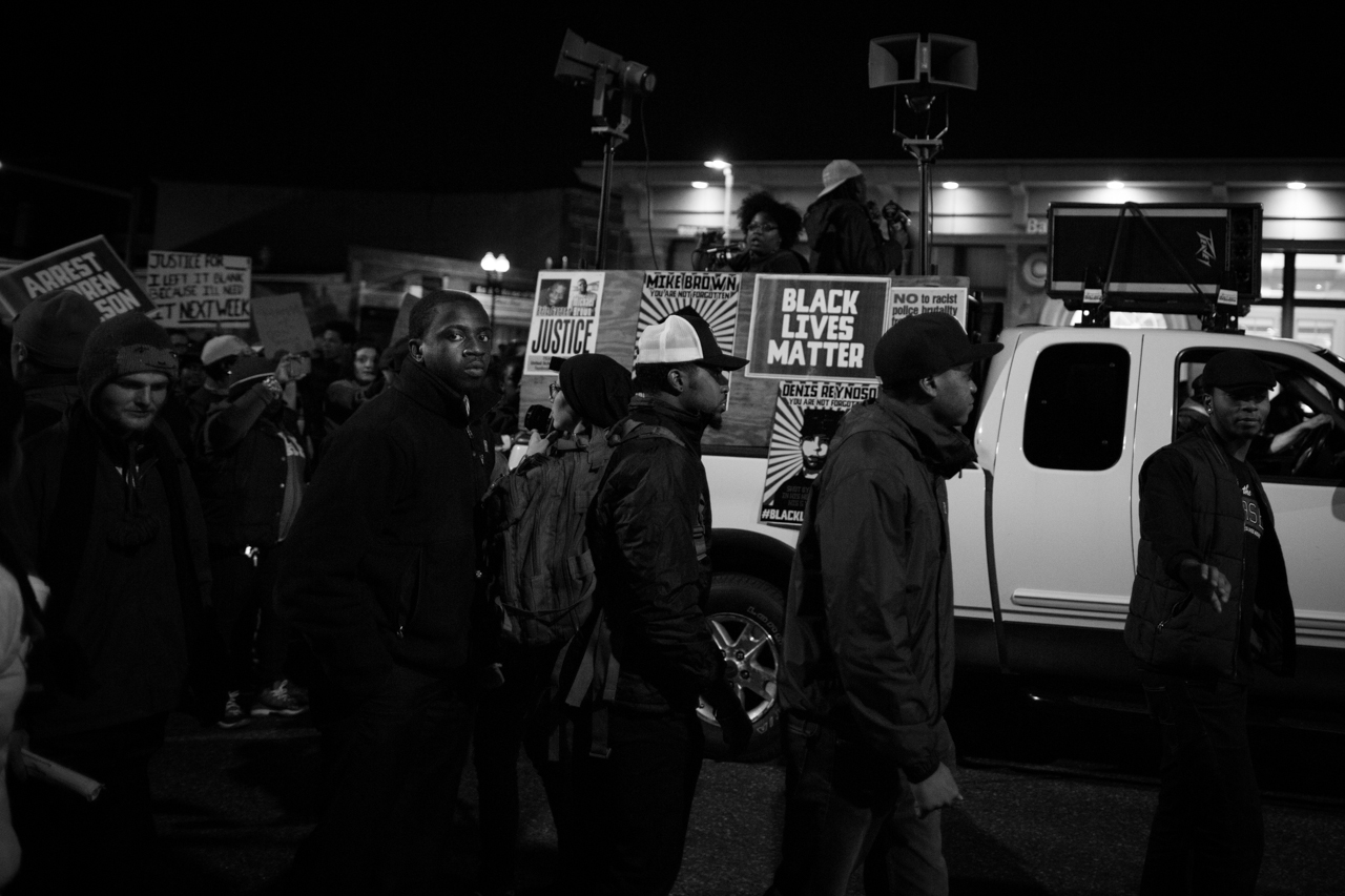 Boston protesters held signs and posters in solidarity with demonstrators in Ferguson, Mo. (Joe Spurr/WBUR)