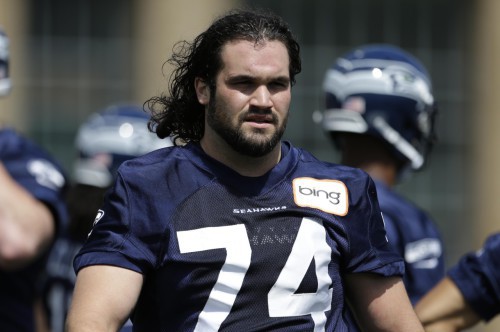 Before he quit the NFL, John Moffitt walks between drills during NFL football minicamp Tuesday, June 11, 2013, in Renton, Wash. (AP Photo/Elaine Thompson)