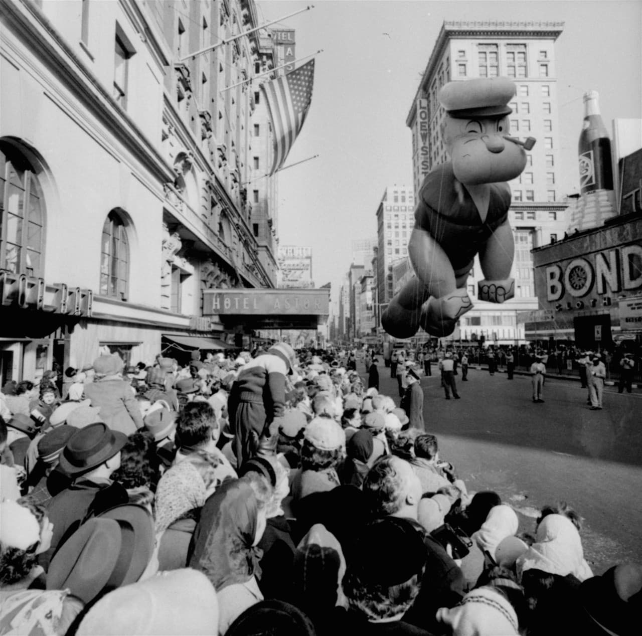 Helium-filled Popeye balloon floats above some of the 1.3 million people who came out for the 1959 parade. (AP)