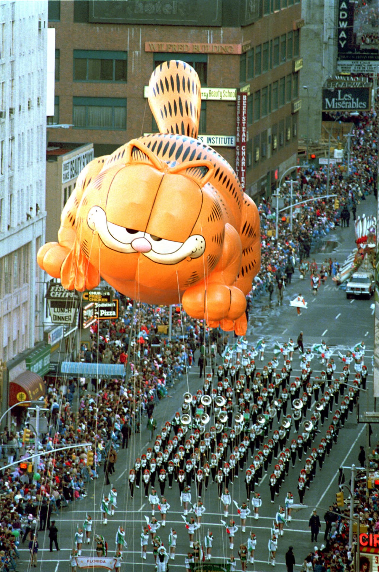 Garfield the Cat floats above a marching band on Broadway in the 1986 parade.  (Ron Frehm/AP)