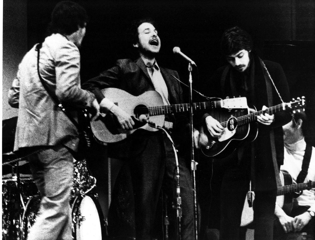 Bob Dylan and The Band performing at a Woody Guthrie memorial concert in 1968, his first since the motorcycle accident. Rick Danko is left, Robbie Robertson right. (AP)