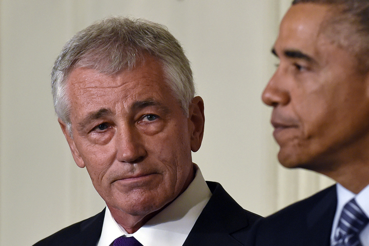 Defense Secretary Chuck Hagel, left, listens as President Barack Obama, right, talks about Hagel's resignation during an event in the State Dining Room of the White House in Washington, Monday, Nov. 24, 2014. (AP)