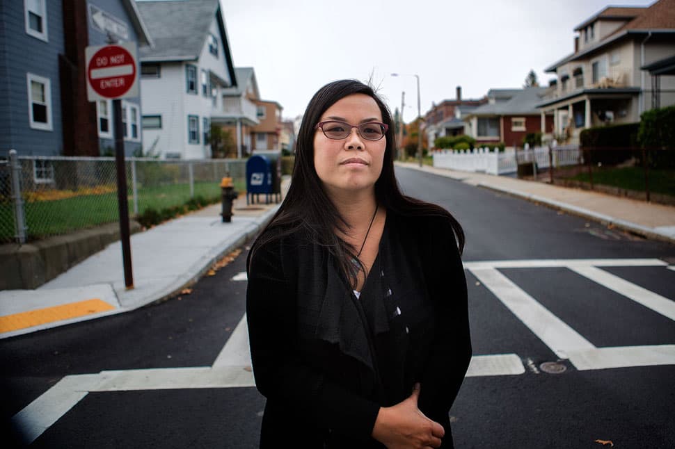 Elaine Ng wasn’t bused; she only needed to walk three blocks to the Mozart School (in the background on the right). But she says older white students waiting for their buses at this corner tormented her with racial slurs. She still lives in Roslindale, and her two kids attend Boston public schools. (Jesse Costa/WBUR)
