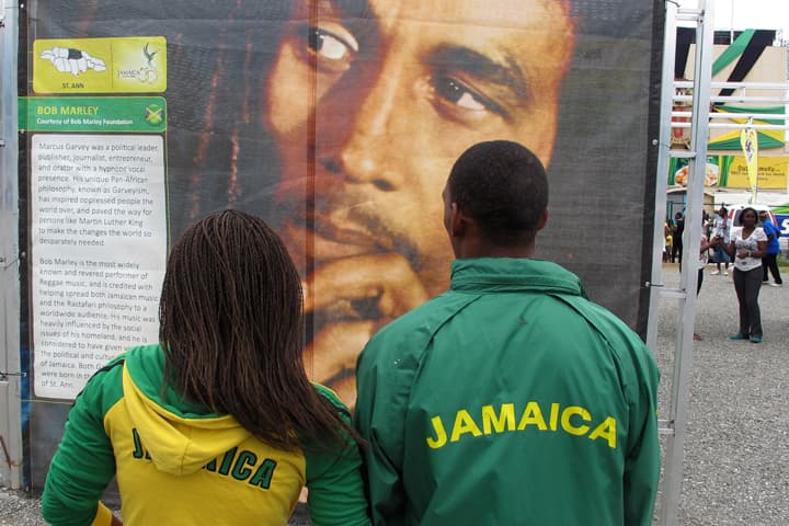 A young couple decked out in "Jamaica" jackets stop at a display honoring reggae icon Bob Marley set up on the grounds of the national stadium in Kingston, Jamaica, Monday, Aug. 6, 2012.