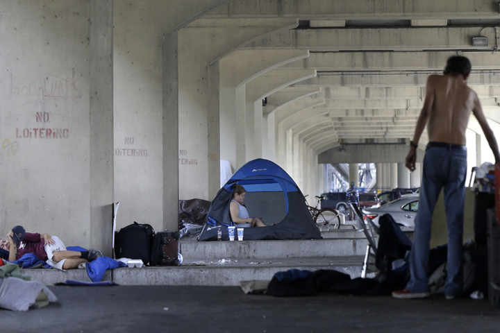 Homeless people stay with their belongings under the Pontchartrain Expressway overpass in New Orleans, Wednesday, Aug. 13, 2014. The city’s health department put up notices Monday giving the estimated 150 homeless people 72 hours to leave the area. (AP)