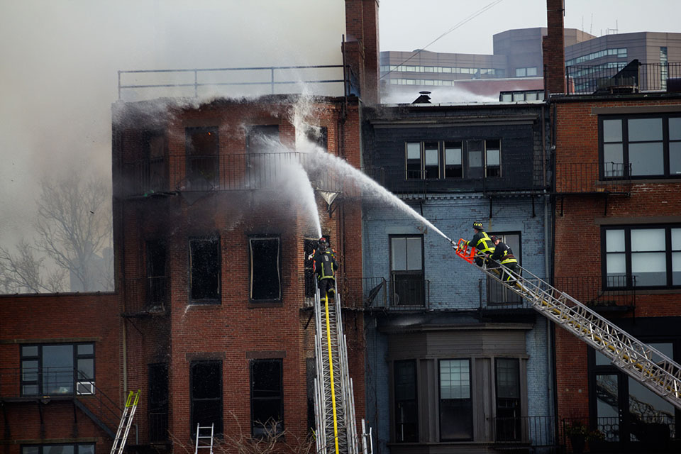 A wind-whipped nine-alarm fire at 298 Beacon St. killed Boston Firefighters Michael Kennedy and Lt. Edward Walsh. (Jesse Costa/WBUR)