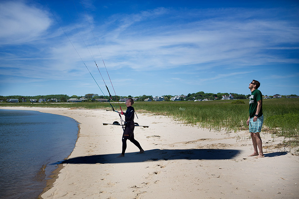 The problem with kiteboarding, according to the U.S. Fish and Wildlife Service, is that the kites and their shadows scare federally protected piping plovers and other shorebirds. Barry Payne prepares to head out onto the water now that he has the kite airborne. (Jesse Costa/WBUR)