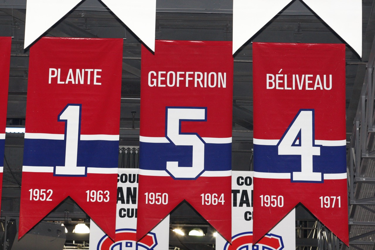 Beliveau's retired #4 hangs in the Bell Centre alongside other Canadiens greats. (Richard Wolowicz/Getty Images)