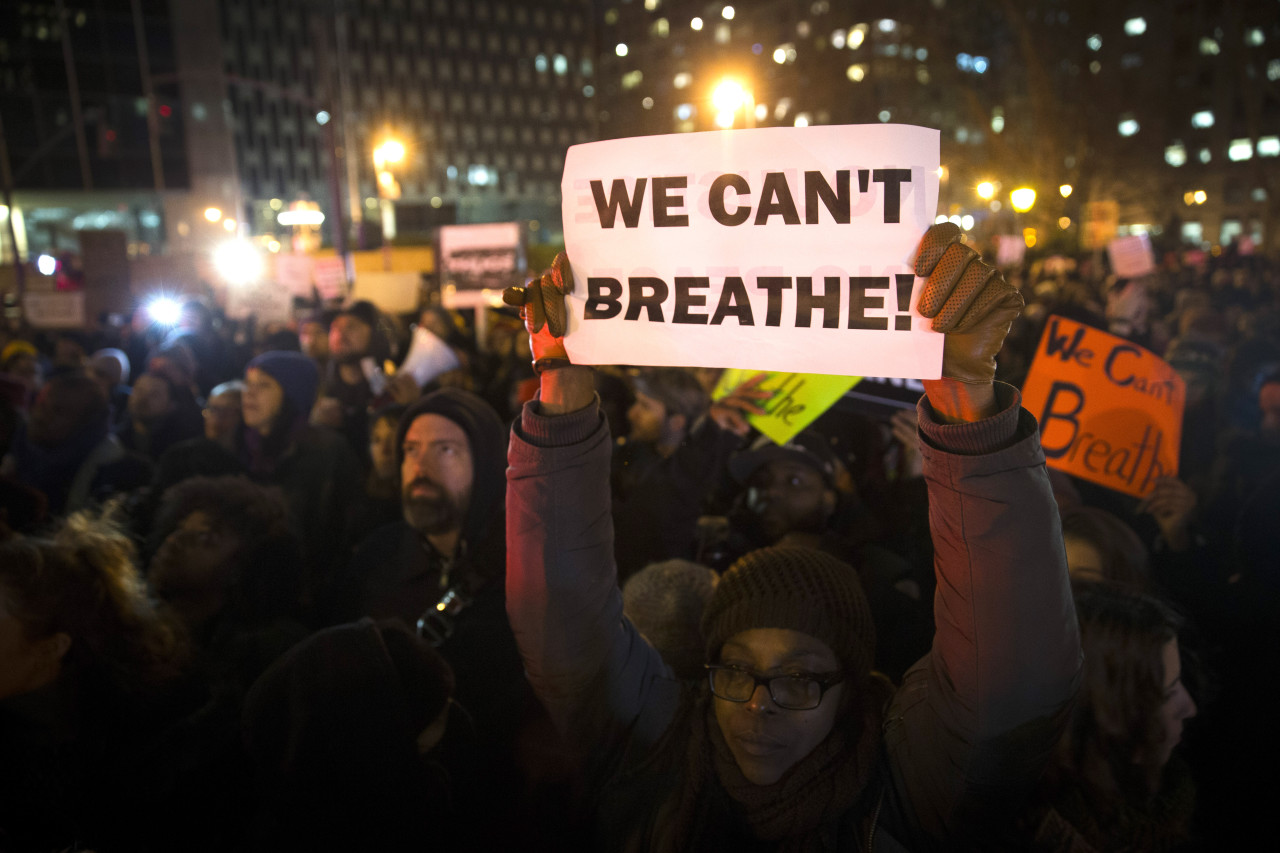 Demonstrators participate in a rally against a grand jury's decision not to indict the police officer involved in the death of Eric Garner, Thursday, in New York. (John Minchillo/AP)