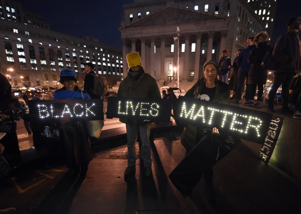 Protesters stand in Foley Square in New York City on December 4, 2014 during demonstration against the chokehold death of an unarmed black father-of-six by a white police officer. It is the second consecutive night that demonstrators took to the streets of New York to condemn a grand jury's decision not to indict the officer over the July 17 death of Eric Garner. (Timothy A. Clary/AFP/Getty Images)