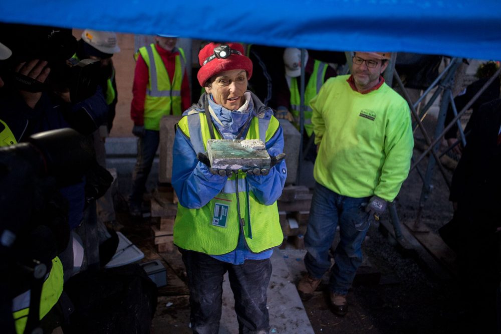 Pamela Hatchfield, head of objects conservation at the MFA, holds the time capsule after extracting it from the cornerstone of the State House. (Jesse Costa/WBUR)