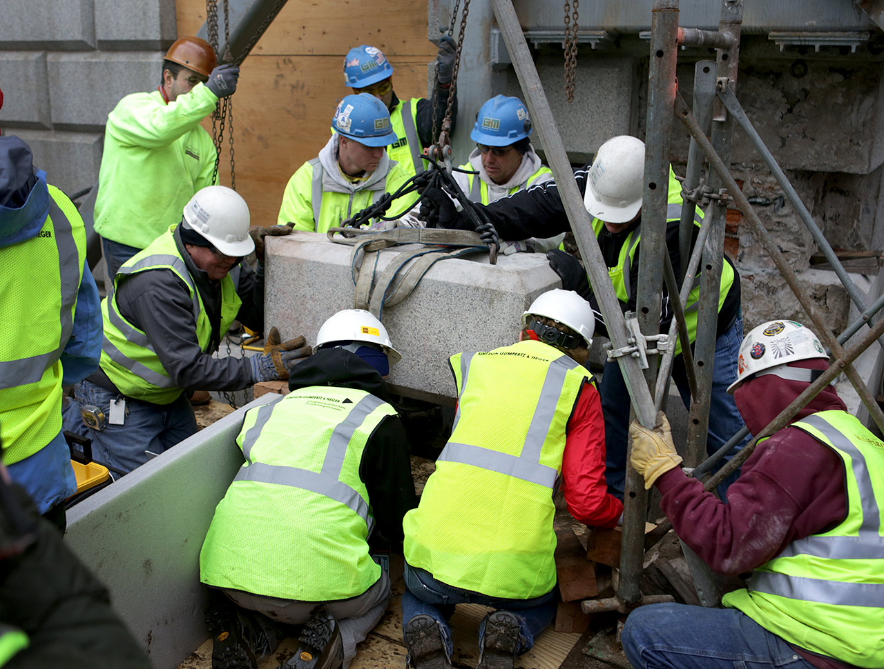 Contractors removed the cornerstone to prepare to extract the time capsule, which was embedded in the bottom. (Jesse Costa/WBUR)