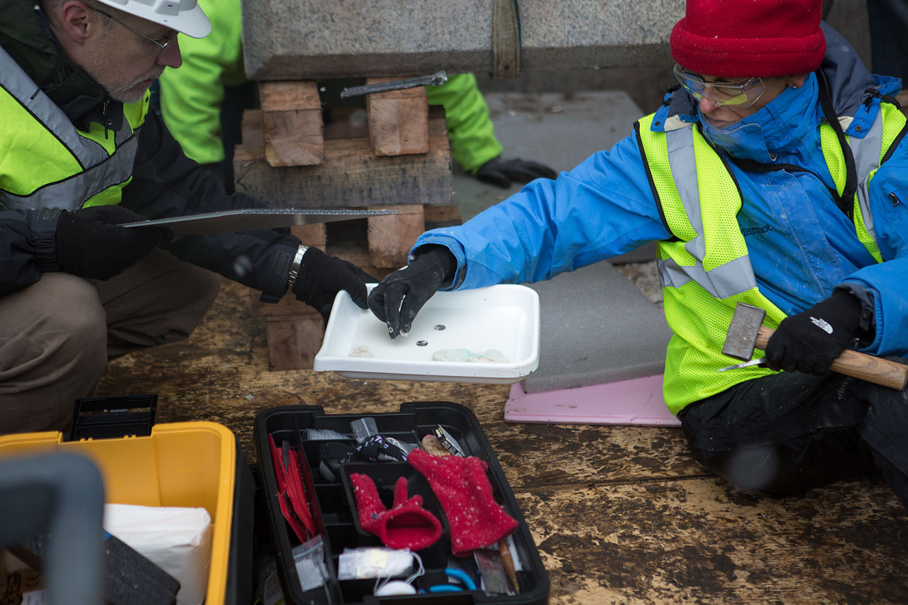 A few coins were found in the plaster that was encasing the time capsule. (Jesse Costa/WBUR)