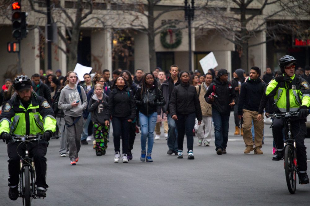 Boston students, accompanied by police, on Tuesday march in protest of recent police shootings. (Jesse Costa/WBUR)