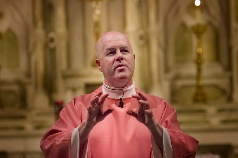 Father Paul O’Brien conducting Sunday Mass at St. Patrick’s Parish in Lawrence. (Jesse Costa/WBUR)